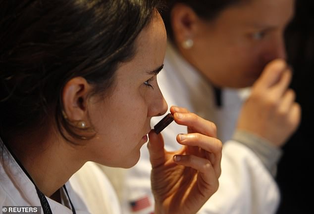 Chefs smell chocolates during a tasting course at a chocolate convention in Lima. The three-day exhibition drew distributors from Latin America and chocolate sommeliers from Europe