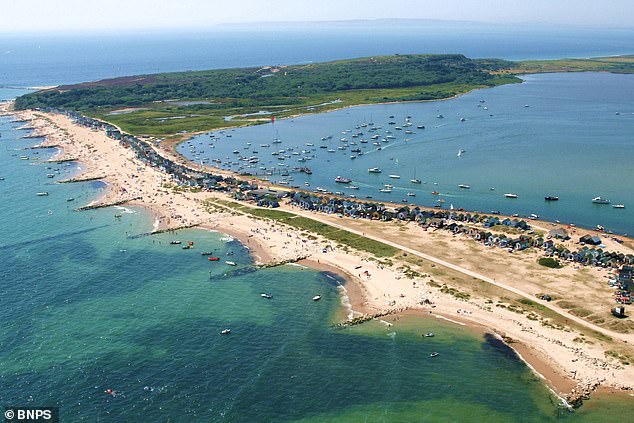 Cars are banned from Mudeford Spit, as owners must take a 20-minute walk, short ferry trip or a novelty land train ride to reach their huts