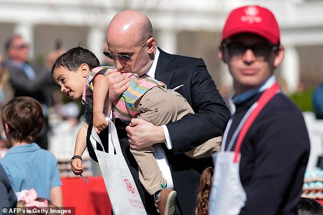White House Deputy Chief of Staff Stephen Miller holds his son as he attends the annual Easter Egg Roll