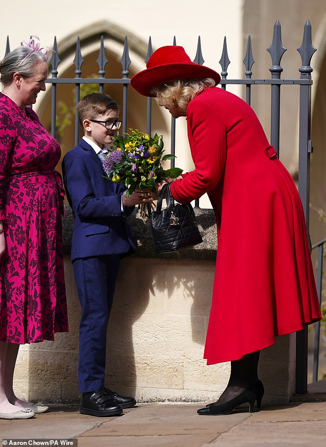 Queen Camilla receives flowers after attending the Easter Service at St George's Chapel yesterday