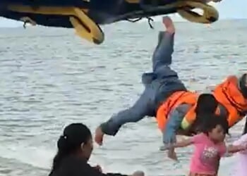 Wild moment tourists are flung into air as inflatable doughnut crashes after speedboat pulling it got too close to shore