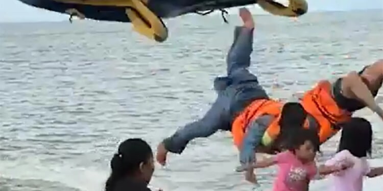 Wild moment tourists are flung into air as inflatable doughnut crashes after speedboat pulling it got too close to shore