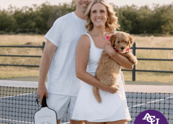 Nick and wife smiling with dog
