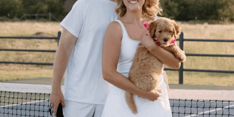 Nick and wife smiling with dog