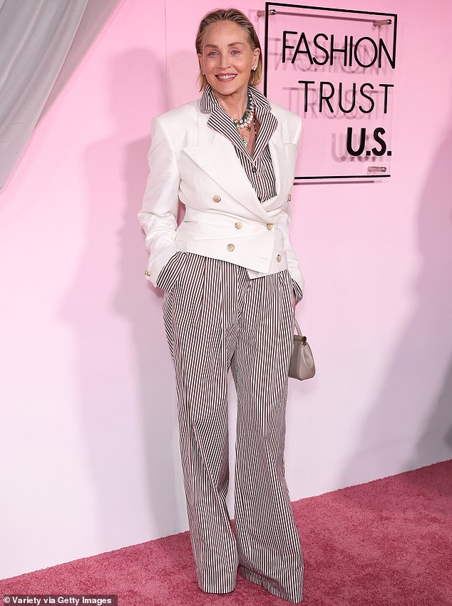 Sharon Stone, 68, exuded an air of upscale springtime glamour, buttoning a tight white blazer over a pinstriped maroon and white shirt and matching loose-fitted slacks