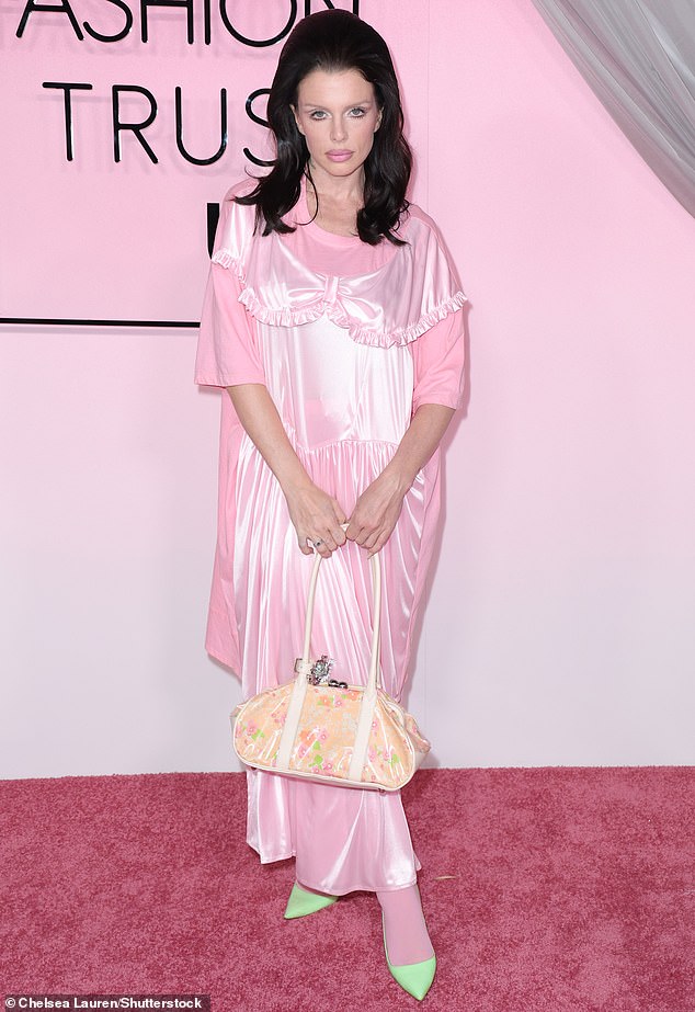 Kanye West's ex Julia Fox opted for a throwback black hairdo, pink dress and extravagant makeup job that channeled Priscilla Presley in the 1960s