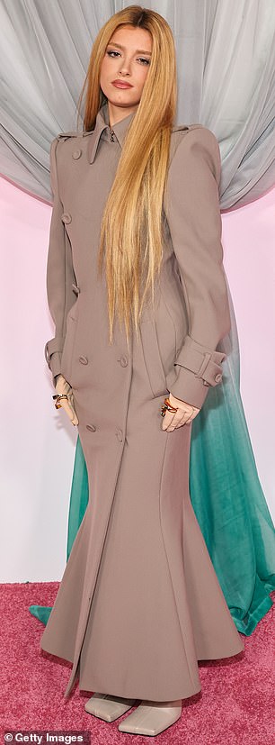 TikTok blonde Dixie D'Amelio let her waist-length locks flow over her floor-length coat-dress