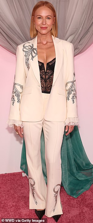 Jewel struck a pose in a trouser suit over a revealing lace top
