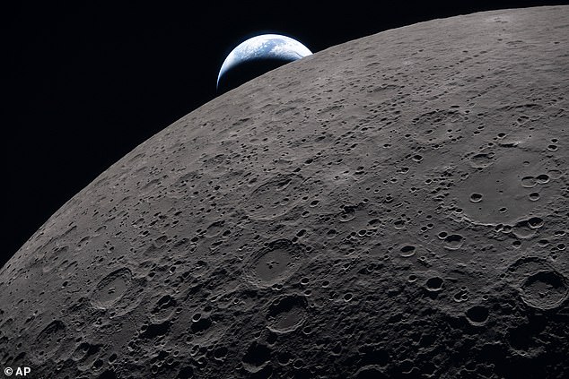 The image of the Earth setting behind the moon was taken just three minutes before the Orion crew capsule lost connection to Mission Control during a planned radio blackout