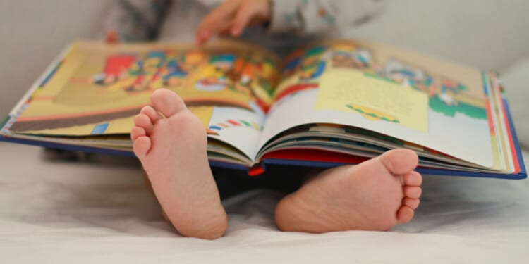 Kids trying to pinch and zoom on real PAGES like an iPad as parents fear books are becoming obsolete