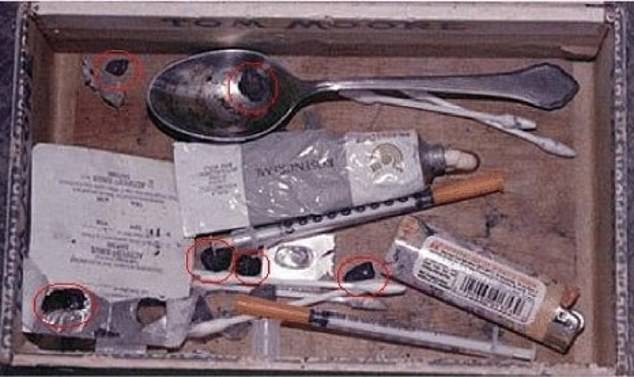 According to Halperin, the unnamed former detective claimed: 'His heroin levels were way too high, which would make it impossible for him to shoot himself in the head.' Pictured is a heroin kit found at Cobain's death scene