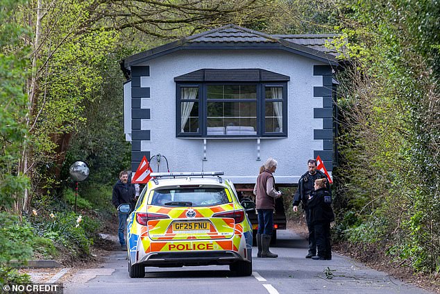 Police on the lane where the mobile home was wedged between bushes on Sunday