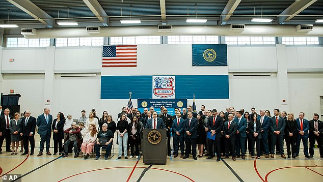 Inside the huge gymnasium at the Suffolk County Police Training Academy that afternoon, around 50 people gathered around a podium