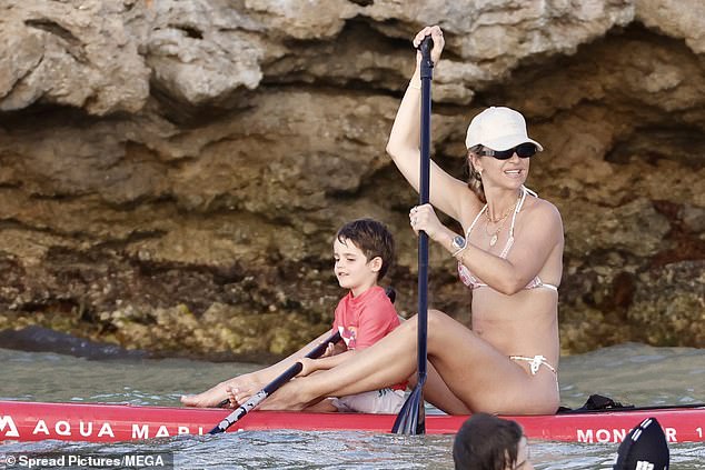 The youngster helped his mother as they worked their way across the water