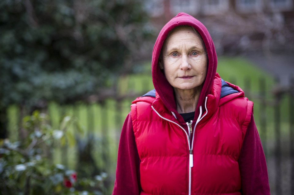 Angela Pleasance as Louise Iver, wearing a red hooded jacket and puffer vest.