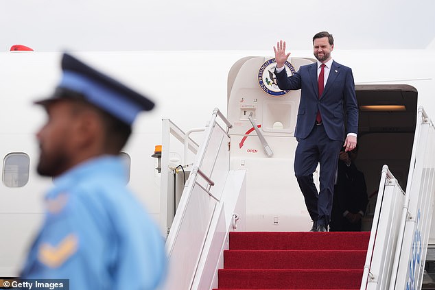 Vice President JD Vance waves as he disembarks from Air Force Two