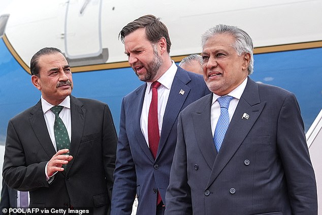 US Vice President JD Vance (C) speaks with Army Chief and Field Marshal Syed Asim Munir (L) and Pakistan's Foreign Minister Ishaq Dar after arriving for the US-Iran peace talks in Islamabad