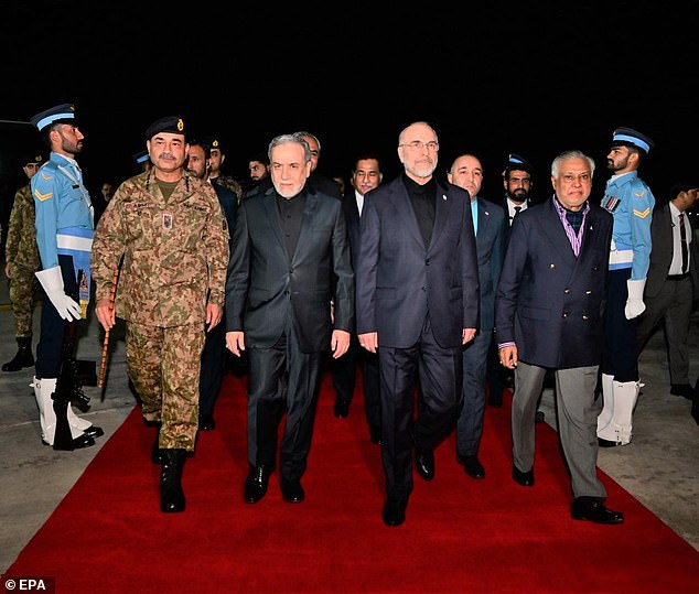 Pakistan's deputy prime minister Ishaq Dar (R) walking with Iran's parliamentary Speaker Mohammad-Bagher Ghalibaf (2-R), Iran's Foreign Minister Abbas Araghchi (2-L), and Pakistan's CDF Field Marshal Asim Munir (L) upon the Iranian delegation's arrival at Nur Khan Airbase in Rawalpindi, Pakistan