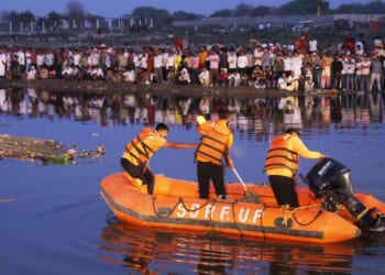 At least 10 dead and a dozen missing after packed boat crashes into bridge and capsizes sparking frantic rescue mission