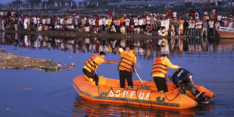 At least 10 dead and a dozen missing after packed boat crashes into bridge and capsizes sparking frantic rescue mission