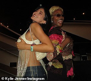 Jenner carried a mini white purse over her shoulder while her voluminous locks flowed down past her shoulders