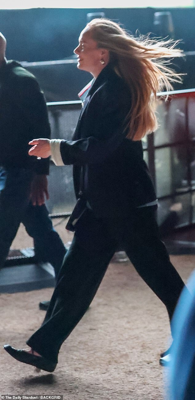 The talented singer, 37, cut a low-key figure as she walked around the festival in a relaxed black suit