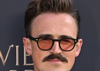Brit pop star looks almost unrecognisable as he shows off dramatic new facial hair at the Olivier Awards