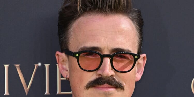 Brit pop star looks almost unrecognisable as he shows off dramatic new facial hair at the Olivier Awards