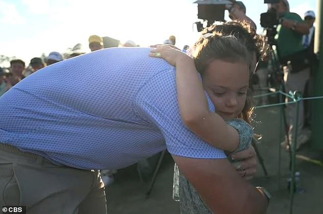 After walking off the green, he first hugged his daughter, Poppy, to celebrate the victory