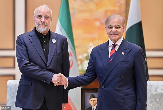In this photo released by the Pakistan Prime Minister Office, Iran's Parliament Speaker Mohammad Bagher Ghalibaf, left, shakes hand with Pakistani Prime Minister Shehbaz Sharif prior to their meeting on Saturday