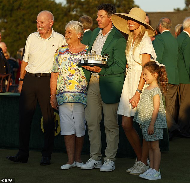 The Northern Irishman celebrated with his parents Gerry and Rosie, wife Erica and daughter Poppy in his Green Jacket