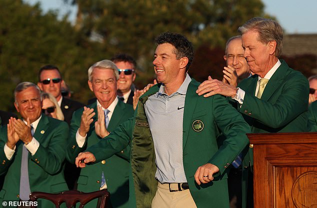 Chairman of Augusta National Golf Club Fred Ridley presents McIlroy with his green jacket
