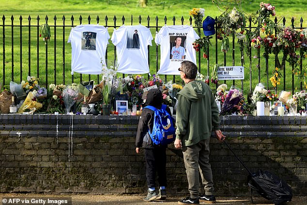 Several bunches of flowers, cards and T-shirts have been placed in memory of the victim