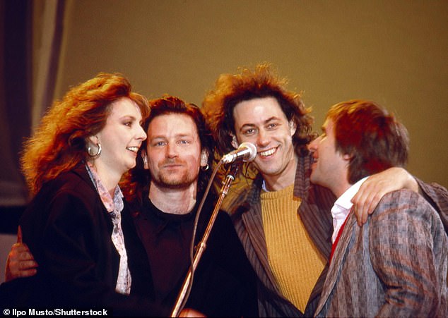 Tributes have poured in for the sister of folk singer Enya, with Bono calling Moya 'an angel' (pictured in 1986 with Sir Bob Geldof and Chris de Burgh)