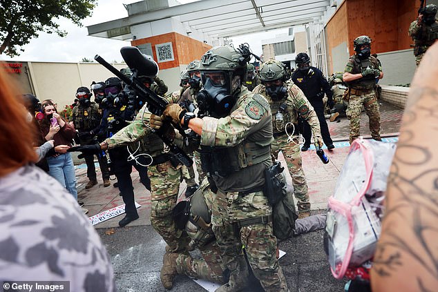 Federal agents, including members of the Department of Homeland Security, the Border Patrol, and police, clash with protesters outside a downtown U.S. Immigration and Customs Enforcement (ICE) facility on October 04, 2025 in Portland, Oregon