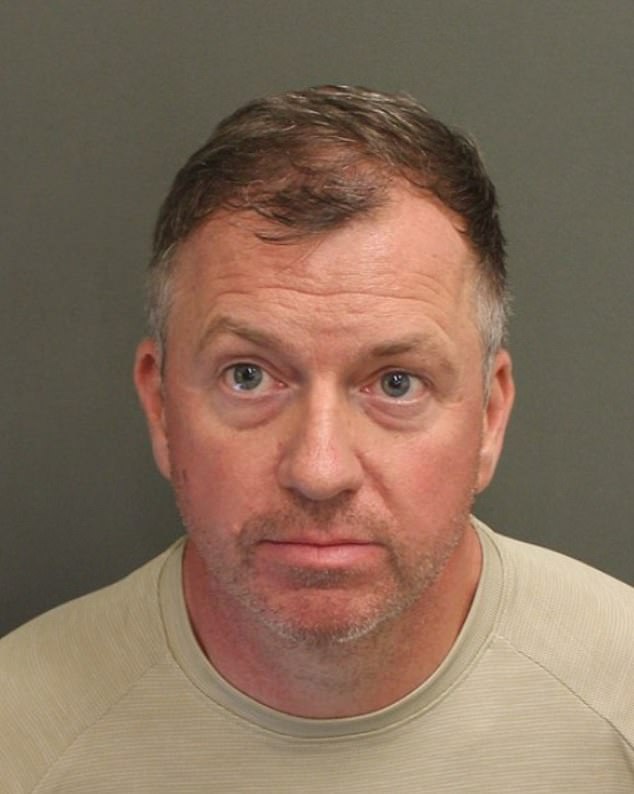 The 47-year-old (pictured) was waiting for the Tiana's Bayou Adventure ride - based on the Princess Tiana character from the Disney movie The Princess and the Frog - when he allegedly put out his arm to stop the girl