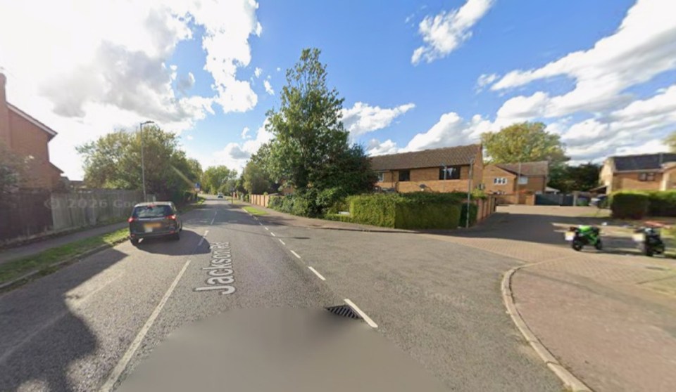 Jackson Road in Aylesbury with a parked car and houses.
