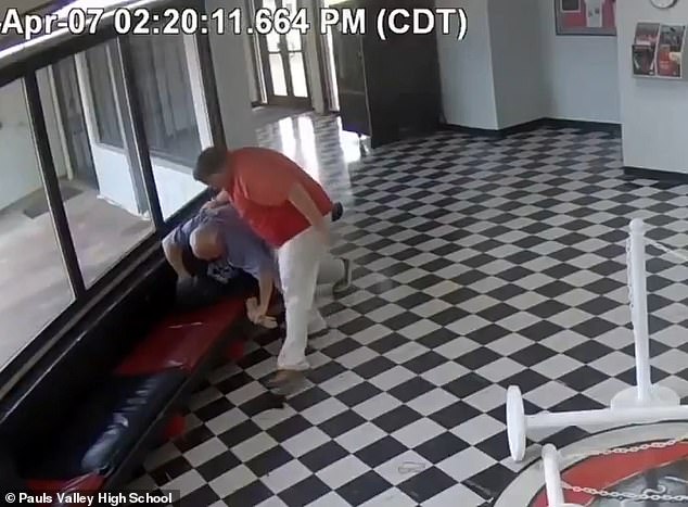 While Hawkins was restrained another school official ran over and kicked away the handgun before carrying it away