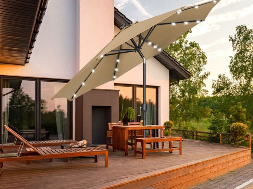 Outdoor patio with a cantilever parasol featuring integrated LED lights.