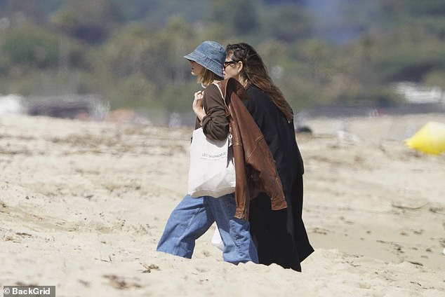 The pair were spotted walking up the beach to the celebrity hotspot together