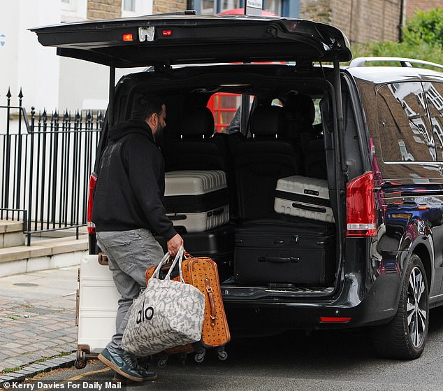 A taxi driver was seen loading bags and cases into the rear of the cab on Wednesday