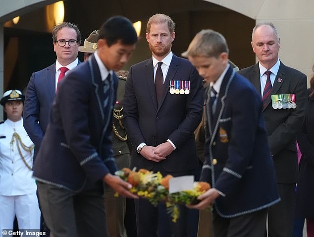 'The photographs of Harry at the Australian War Memorial in Canberra, medals on display, surrounded by dignitaries and children in school uniform, could easily have been taken on his and Meghan’s official 2018 tour to the country,' writes Rebecca English