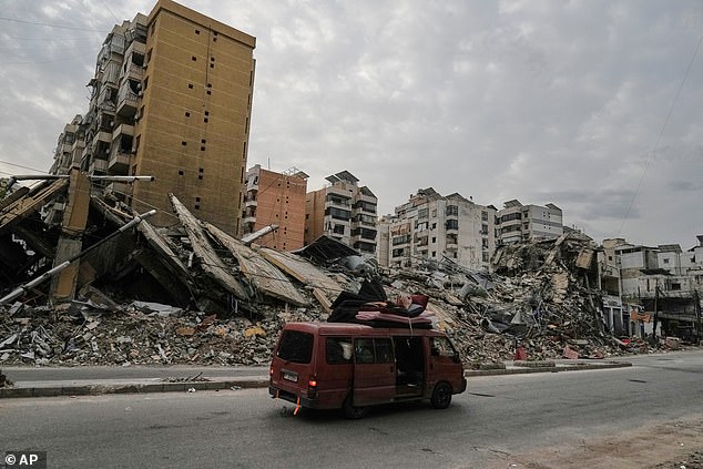 Displaced residents are seen returning in a vehicle loaded with belongings to Dahiyeh, in Beirut's southern suburbs