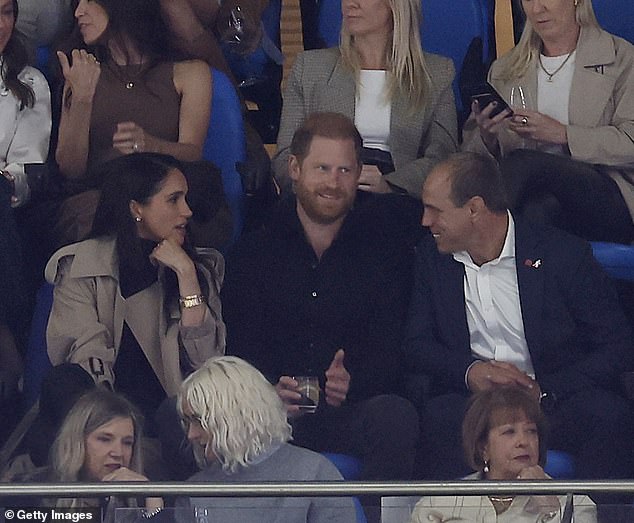 Prince Harry and Meghan talk to Australian Rugby CEO Phil Waugh as they attend the Waratahs Friday night Super Rugby clash at at Allianz Stadium