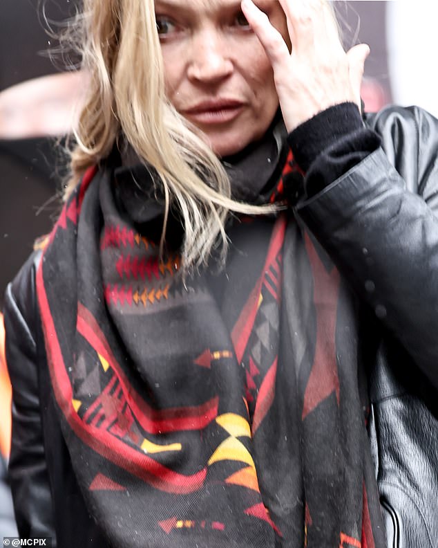 Kate wore an all-black outfit consisting of black, straight leg jeans, a leather jacket and a red patterned silk scarf
