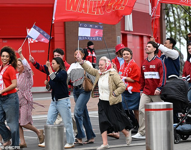 Extras were filmed marching past the pub with Tommy Hilfiger flags, dressed in a series of red and striped looks