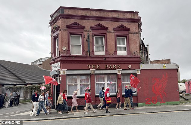 They were seen walking past with the football teams logo on the wall