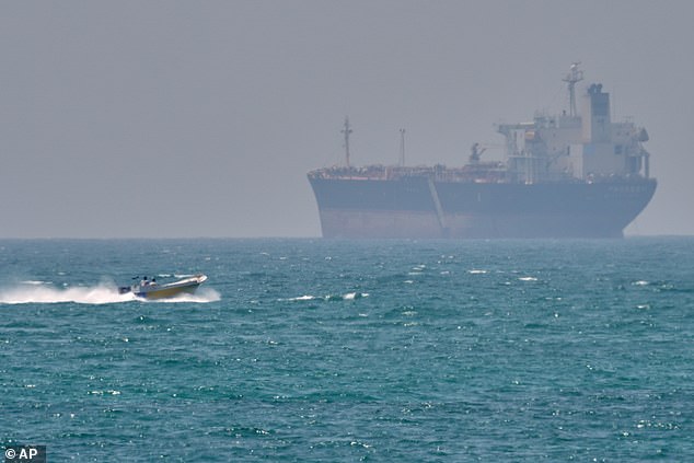 At least two Indian merchant vessels reported being hit by gunfire in the Strait. Pictured: a boat anchored off the cost of Iran near the Strait