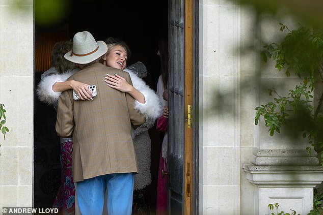 Roxy gave her father-in-law a warm hug as she greeted her guests back the wedding venue