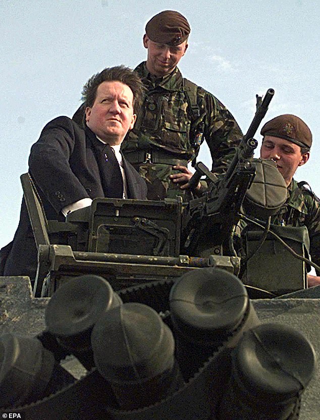 Taking aim: Then-defence secretary George Robertson on a Challenger tank in 1999